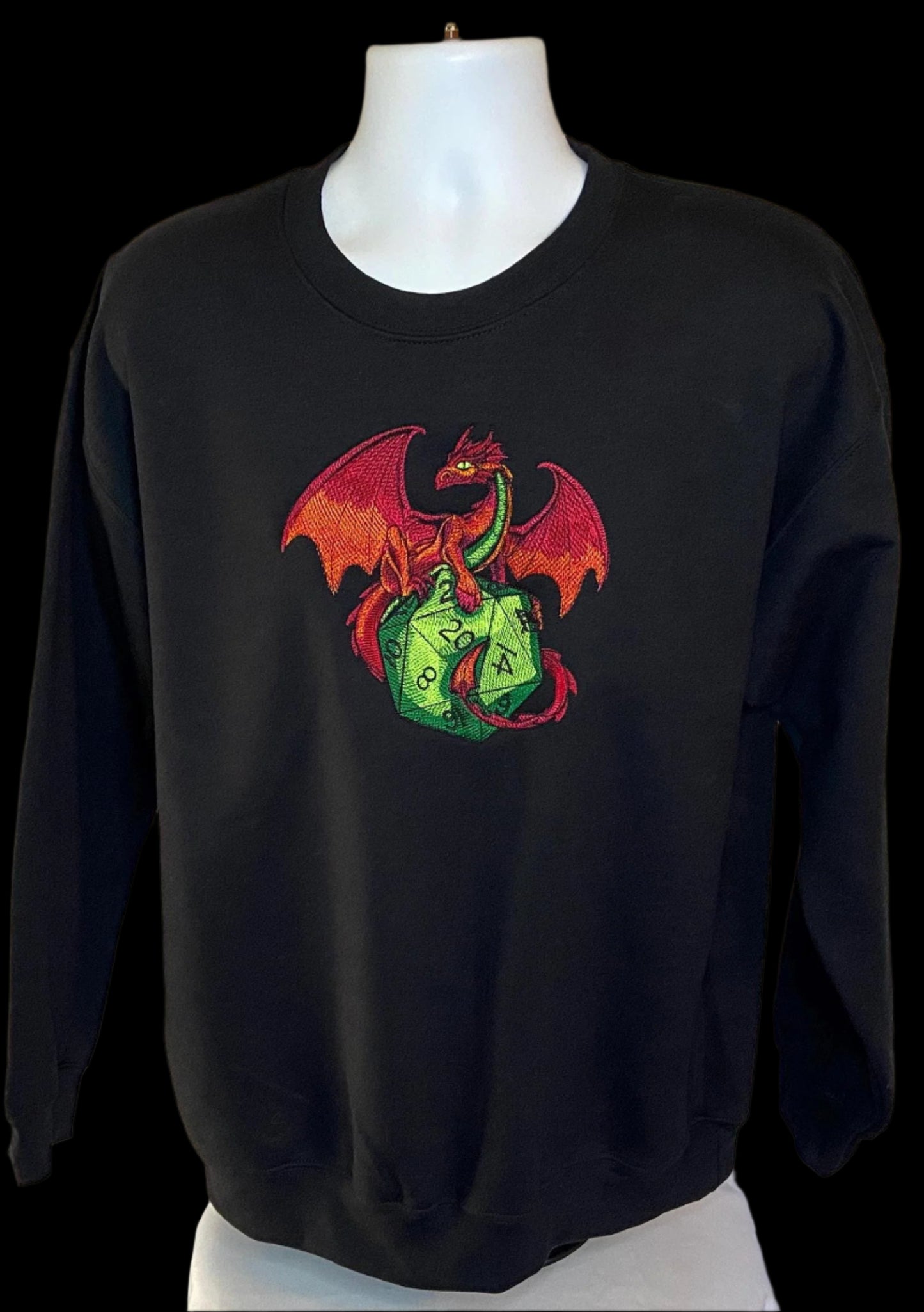 Black sweatshirt with a colorful dragon design on a mannequin against a white background