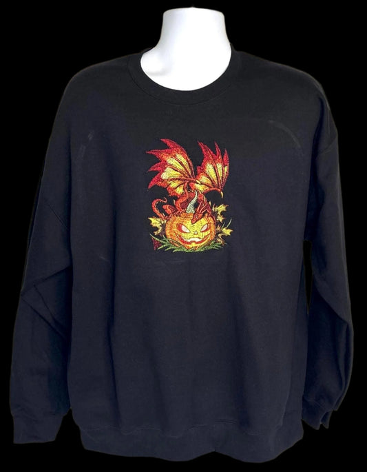 Black sweatshirt with a dragon and pumpkin design on a mannequin against a white background