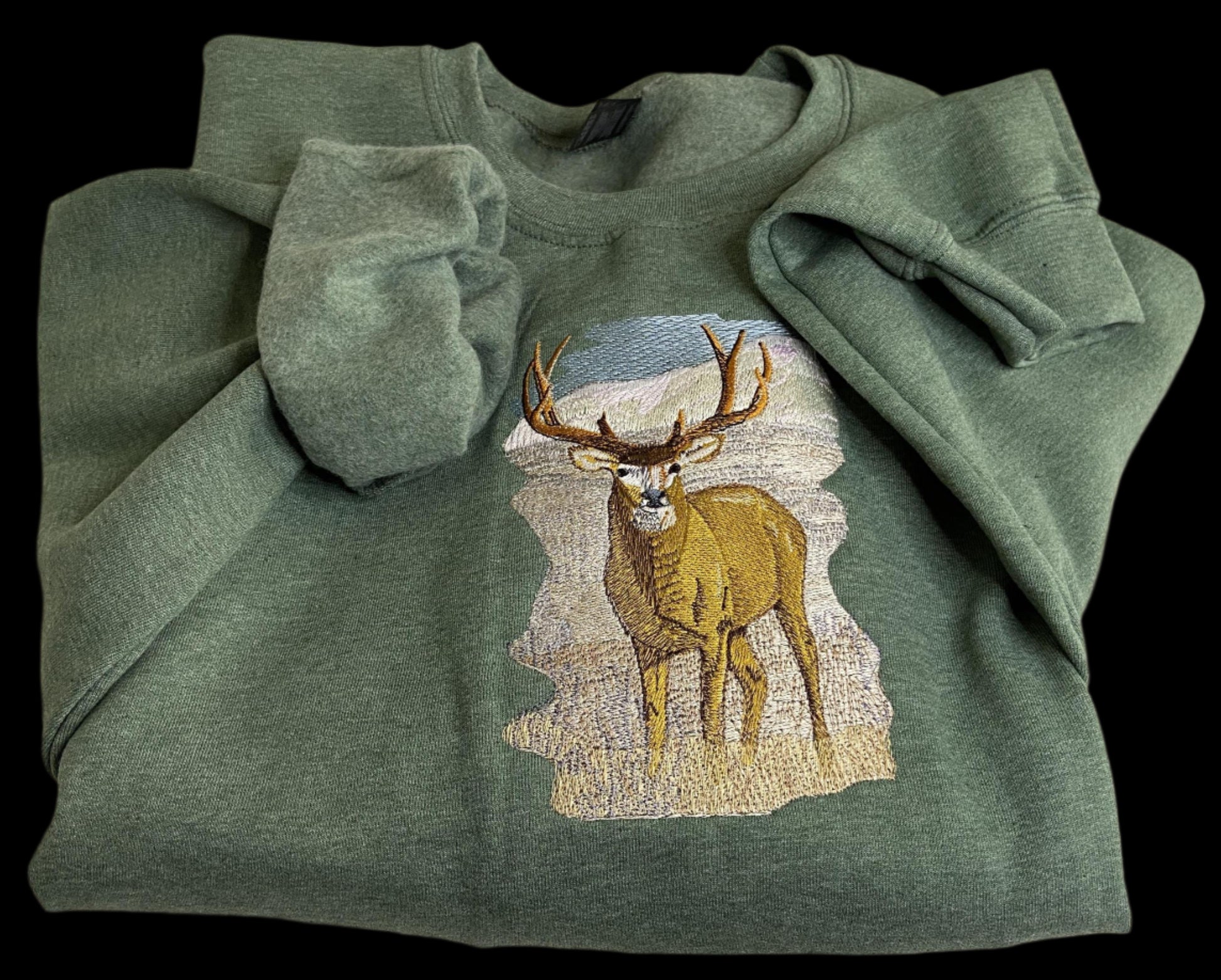 Green sweatshirt with a deer design on a white background